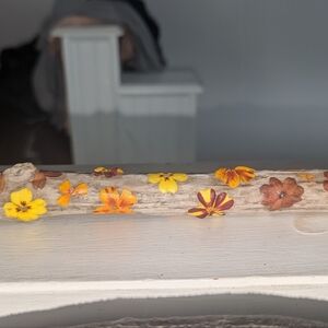 Driftwood with real flowers decor. Pretty orange, yellow and marrons. About a fo
